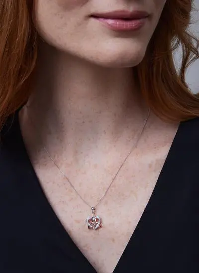 Close up shot of red haired woman wearing Celtic Trinity 